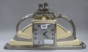 An Art Deco French pottery mantel clock, decorated with pheasants