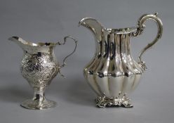 A George III silver inverted pear shaped cream jug, London, 1773 and a Victorian silver cream jug.