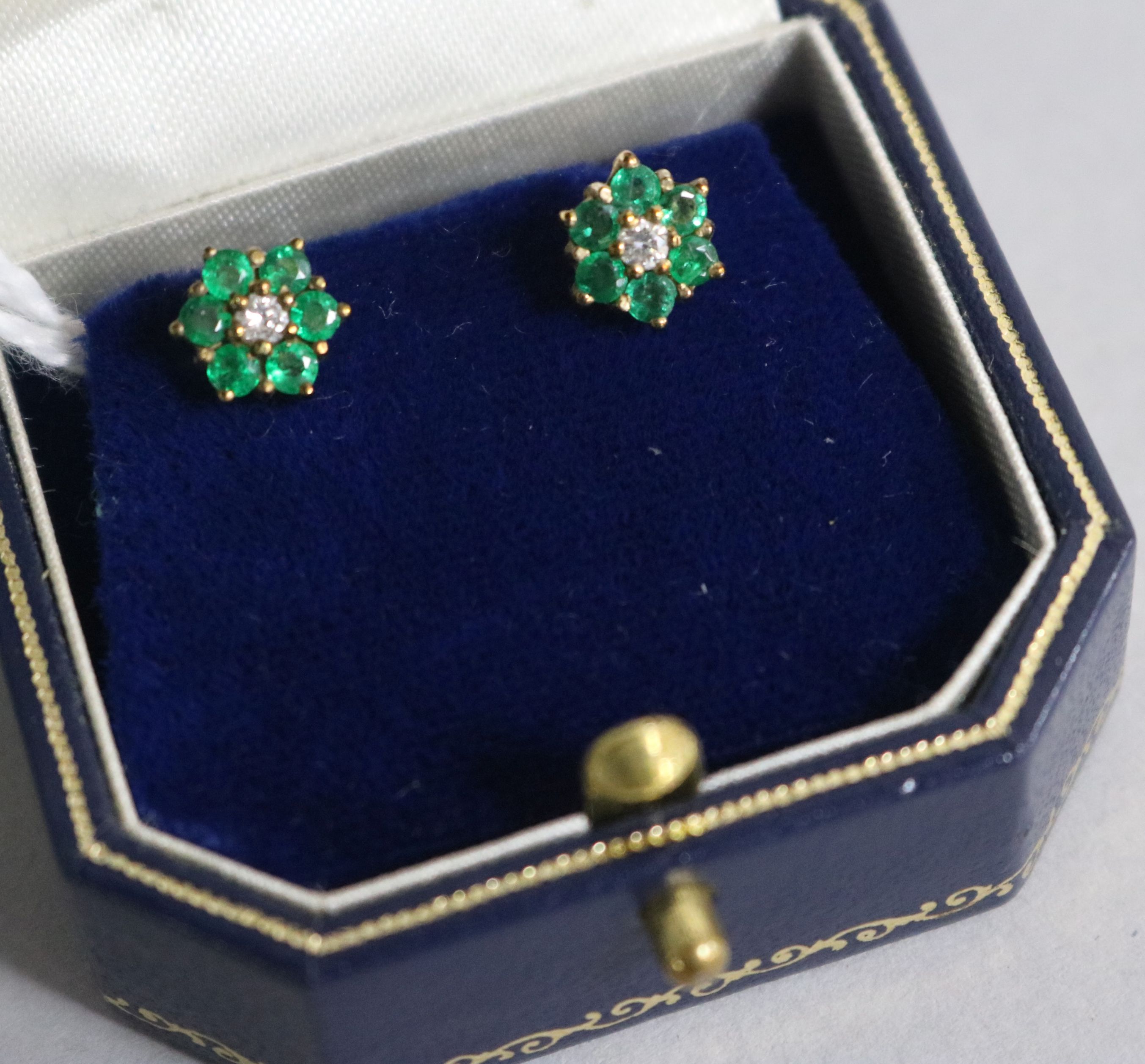A pair of 9ct gold emerald and diamond ear studs