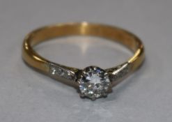 A 22ct gold and single stone diamond ring with diamond set shoulders, size Q.