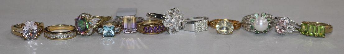 Twelve assorted modern 9ct and gem set dress rings.