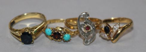 A late Victorian 18ct gold and gem set ring and three other yellow metal and gem set rings including