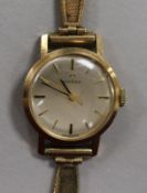 A lady's 9ct gold Omega manual wind wrist watch, on 9ct gold bracelet.