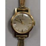 A lady's 9ct gold Omega manual wind wrist watch, on 9ct gold bracelet.