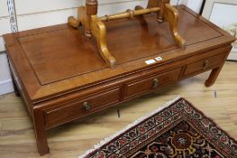 A low Chinese hardwood three drawer table, W.127cm