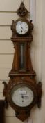 A carved oak barometer, W.30cm