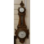 A carved oak barometer, W.30cm