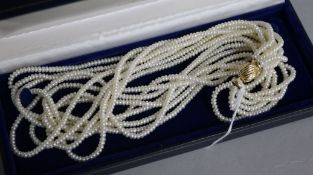 A multi strand seed pearl necklace with 14ct gold clasp, with Mikimoto box, 44cm.