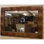 An oak framed wall mirror, W.100cm
