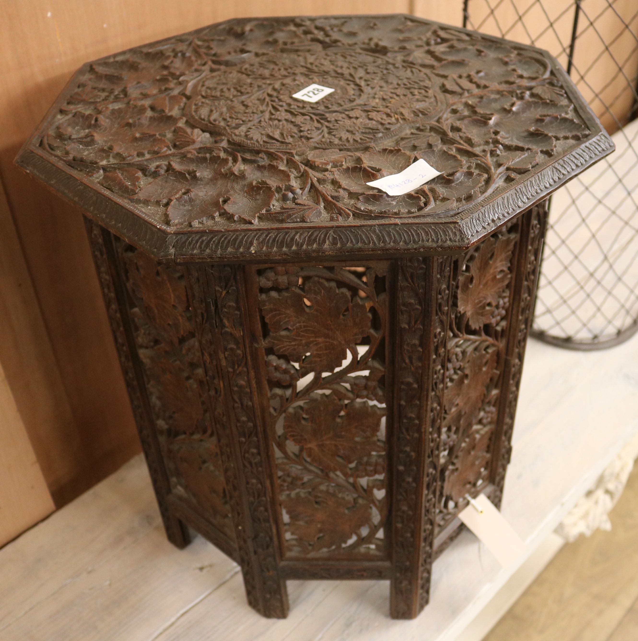 An Indian carved wood octagonal table, W.46cm