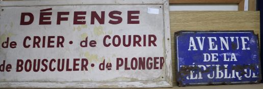 An enamel sign and a painted wood sign