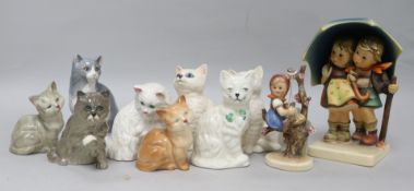 Two Hummel figures of children and a collection of cat figures by Royal Doulton, Beswick and