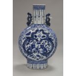 A Chinese blue and white moon flask decorated with dragons