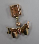 A 1950's 14ct gold and gem set Crawford lapel watch, with 14ct gold and gem set ribbon bow brooch,