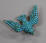 A Victorian silver, gold and turquoise encrusted bird brooch, with gem set eyes, (one turquoise