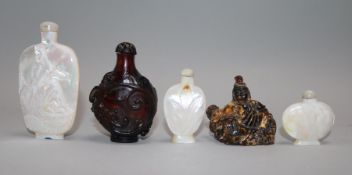 Three Chinese carved mother-of-pearl snuff bottles and two other snuff bottles