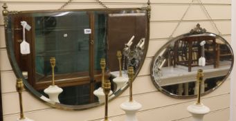 A bevelled mirror in decorative brass frame and another mirror, W.77cm and 69cm