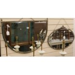 A bevelled mirror in decorative brass frame and another mirror, W.77cm and 69cm