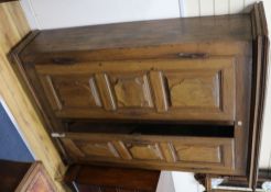 A 19th century French provincial oak armoire, fitted two doors with cartouche-shaped panels W.143cm