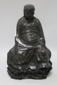 A 17th century Chinese bronze of an Emperor on wooden stand