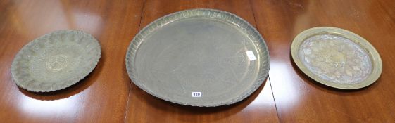 Three Islamic brass dishes, Largest W.55cm