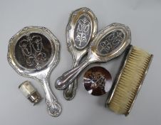 A silver and tortoiseshell five piece brush set and two similar toilet jars.