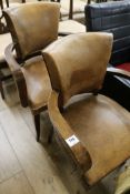 A pair of French leather and beech elbow chairs