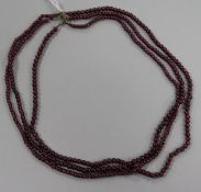 A triple strand garnet? bead necklace, 42cm.