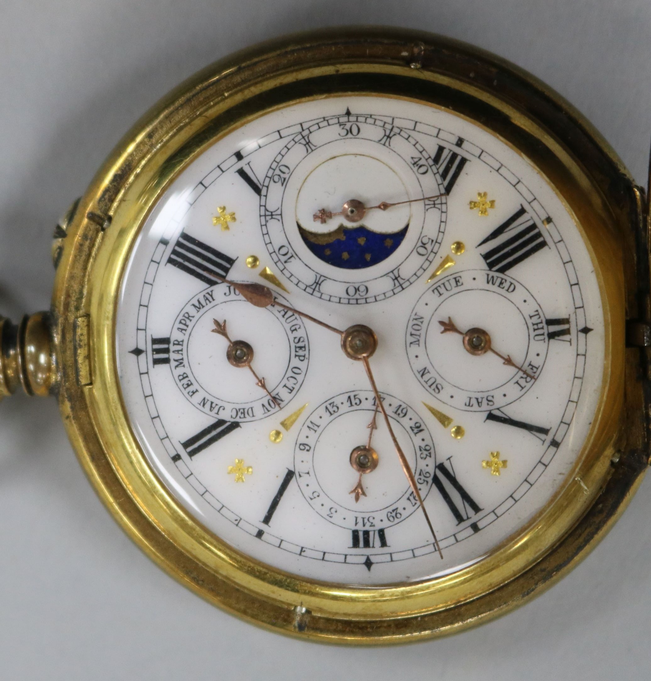 An engine turned gilt metal triple calendar and moonphase pocket watch.