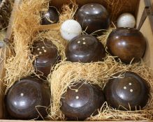 A Victorian cased set of eight lignum vitae garden bowls and two white pottery jacks