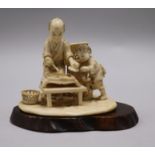 A Japanese carved ivory man and child