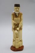 A Japanese ivory figure of a scribe