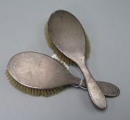 Two 1950's engine turned silver mounted hair brushes.