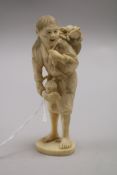 A Japanese carved ivory man with basket of toads