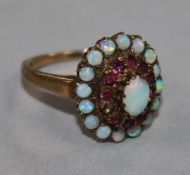 A 9ct gold, ruby and white opal cluster dress ring, one ruby missing, size P.