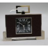A Cartier Art Deco style chrome and faux shagreen desk alarm timepiece, height 8.5cm over handle.