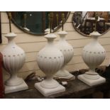 A set of four painted lamp bases