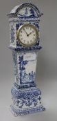 A Continental tinglazed pottery model of a longcase clock