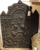 A cast iron fireback decorated with cherubs, bearing date '1679', W.58cm