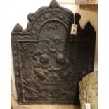 A cast iron fireback decorated with cherubs, bearing date '1679', W.58cm