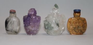 Four Chinese hardstone snuff bottles; rock crystal, amethyst quartz, hair crystal and brown jasper