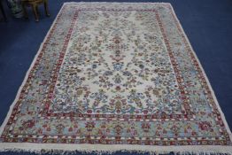 A Tabriz style cream ground carpet, woven with scattered flowers 315 x 214cm