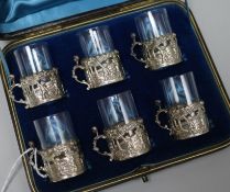 A late Victorian cased set of six repousse silver cup holders by William Comyns, Birmingham, 1891,