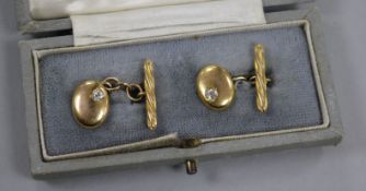 A cased pair of early 20th century high carat gold and diamond set oval cufflinks.