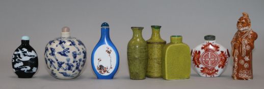Eight Chinese porcelain snuff bottles, one slip decorated with cranes on a black ground and