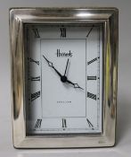 A silver framed Harrods quartz clock