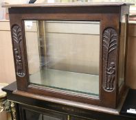 A African hardwood display cabinet, carved with figures beside palm trees, W.2ft 2in.