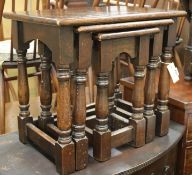 An oak oval gateleg table and a nest of three oak tables