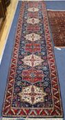 A Kazak style runner 11ft 2in x 2ft 6in.