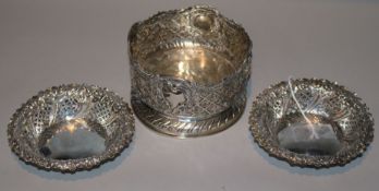 A pair of late Victorian pierced silver bonbon dishes and a Continental pierced silver bottle